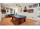 Spacious game room with a blue felt pool table, comfortable seating, and ample wall decor at 10903 Skymont Dr, Huntersville, NC 28078
