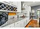 A kitchen with granite countertops, stainless appliances, white cabinetry and wine rack at 10903 Skymont Dr, Huntersville, NC 28078