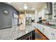 A kitchen with granite countertops, stainless appliances, and a kitchen island and seating at 10903 Skymont Dr, Huntersville, NC 28078