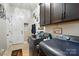 Laundry room features modern washer and dryer, storage cabinets, and a folding area at 10903 Skymont Dr, Huntersville, NC 28078