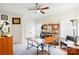 Cozy home office with wood desk, ceiling fan, and natural light streaming through the windows at 10903 Skymont Dr, Huntersville, NC 28078