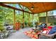 Inviting screened-in porch with comfortable seating, ceiling fan, and views of the lush backyard at 10903 Skymont Dr, Huntersville, NC 28078