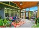 Relaxing screened porch featuring a ceiling fan, cozy furniture, and a vibrant outdoor view at 10903 Skymont Dr, Huntersville, NC 28078