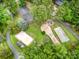 Aerial view featuring a tennis court and playground amid lush greenery at 1102 Lake Montonia Rd, Kings Mountain, NC 28086