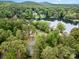 Aerial shot of a lakeside community surrounded by lush green trees at 1102 Lake Montonia Rd, Kings Mountain, NC 28086