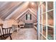 Light-filled attic room with light wood walls, wicker furniture, and large windows at 1102 Lake Montonia Rd, Kings Mountain, NC 28086