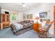 Comfortable bedroom with a ceiling fan, window with natural light, and a mix of wooden furniture at 1102 Lake Montonia Rd, Kings Mountain, NC 28086