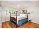 Bedroom with hardwood floors, a four-poster bed, and a window with a view at 1102 Lake Montonia Rd, Kings Mountain, NC 28086