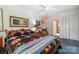 Bedroom featuring a colorful quilt, ceiling fan, and closet doors, leading to a bathroom at 1102 Lake Montonia Rd, Kings Mountain, NC 28086