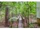Wooden bridge path leading through a lush green landscape at 1102 Lake Montonia Rd, Kings Mountain, NC 28086
