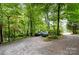 Stone driveway with parking area surrounded by lush trees at 1102 Lake Montonia Rd, Kings Mountain, NC 28086