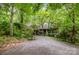 Secluded home nestled among beautiful trees with a long driveway and a welcoming porch at 1102 Lake Montonia Rd, Kings Mountain, NC 28086