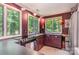 The kitchen features stainless steel sink, wood cabinets, and views of trees at 1102 Lake Montonia Rd, Kings Mountain, NC 28086