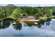 Picturesque lake view featuring a covered pier, a small sandy beach and a lakeside recreation building at 1102 Lake Montonia Rd, Kings Mountain, NC 28086