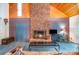 Comfortable living room featuring a prominent brick fireplace, wood ceiling, and ample natural light at 1102 Lake Montonia Rd, Kings Mountain, NC 28086