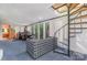 Spacious sitting area with spiral staircase, large windows, and backyard views at 1102 Lake Montonia Rd, Kings Mountain, NC 28086