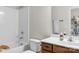 Bright bathroom features a white tub, toilet, vanity, and a dark wooden cabinet at 1124 Greenbridge Dr, Matthews, NC 28105