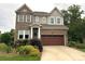 Charming two-story home featuring a brick facade, well-manicured lawn, and a welcoming front entrance at 1124 Greenbridge Dr, Matthews, NC 28105
