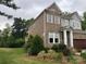 Well-maintained two-story home with brick siding, lush landscaping, and a green lawn at 1124 Greenbridge Dr, Matthews, NC 28105
