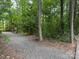 Gravel path through a wooded area, inviting residents to explore nature and enjoy the outdoors at 1124 Greenbridge Dr, Matthews, NC 28105