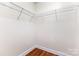 Walk-in closet with wire shelving and hardwood floors at 1136 W 1St St, Charlotte, NC 28202