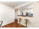 View of the dining space showing hardwood floors and a decorative partition to the kitchen at 1136 W 1St St, Charlotte, NC 28202