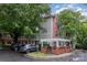 Charming condo building with parking lot, surrounded by lush trees at 1136 W 1St St, Charlotte, NC 28202