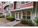 The exterior features a covered entrance, well-maintained landscaping and neutral siding with a touch of red brick at 1136 W 1St St, Charlotte, NC 28202