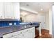 Updated kitchen featuring stainless steel appliances, bright lighting, and blue tile backsplash at 1136 W 1St St, Charlotte, NC 28202