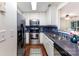 Updated kitchen featuring stainless steel appliances, bright lighting, ample counter space, and blue tile backsplash at 1136 W 1St St, Charlotte, NC 28202