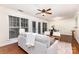 Bright living room with hardwood floors, a ceiling fan, neutral colored walls, and natural light at 1136 W 1St St, Charlotte, NC 28202