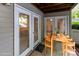 Covered patio with wood table and chairs and view of trees at 1136 W 1St St, Charlotte, NC 28202
