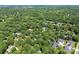 Wide aerial view showing a neighborhood with lush greenery and mature trees at 116 Oak Creek Dr, Charlotte, NC 28270