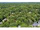 Aerial view of a neighborhood with houses nestled among mature trees and lush greenery at 116 Oak Creek Dr, Charlotte, NC 28270