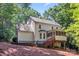 Backyard with a stone patio, dining table, and stairs to a screened porch at 116 Oak Creek Dr, Charlotte, NC 28270