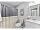 Bathroom with a grey shower curtain, flowers, mirror, and white vanity at 116 Oak Creek Dr, Charlotte, NC 28270