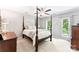 This bedroom features a four-poster bed, wood furniture and natural light at 116 Oak Creek Dr, Charlotte, NC 28270