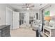 Neutral bedroom with a ceiling fan, mirrored closet, chair, and side table with a lamp at 116 Oak Creek Dr, Charlotte, NC 28270
