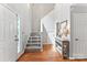 Welcoming foyer featuring hardwood floors, a staircase with baby gate, and console table at 116 Oak Creek Dr, Charlotte, NC 28270