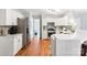 Updated kitchen features stainless steel appliances, white cabinets, and hardwood floors at 116 Oak Creek Dr, Charlotte, NC 28270