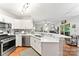 This open kitchen features stainless steel appliances, a breakfast bar, and hardwood floors at 116 Oak Creek Dr, Charlotte, NC 28270