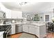 This open kitchen features stainless steel appliances, white cabinets, and a breakfast bar at 116 Oak Creek Dr, Charlotte, NC 28270