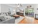 Cozy living room with a fireplace, hardwood floors, and access to the outdoor space at 116 Oak Creek Dr, Charlotte, NC 28270
