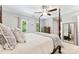 This main bedroom features neutral walls, bright windows, and a four-poster bed, creating a relaxing retreat at 116 Oak Creek Dr, Charlotte, NC 28270