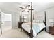 This main bedroom is serene with its simple decor, four-poster bed, and ample space for relaxation at 116 Oak Creek Dr, Charlotte, NC 28270