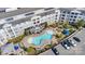 Aerial view of condo community with a kidney shaped pool, lounge areas, and parking at 117 Langhorne Dr, Mount Holly, NC 28120