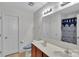 Functional bathroom with double sinks, tile flooring, and a separate toilet area at 117 Langhorne Dr, Mount Holly, NC 28120
