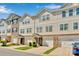 Charming townhouse complex featuring beige siding, brick accents, and well-manicured lawns in a desirable neighborhood at 117 Langhorne Dr, Mount Holly, NC 28120