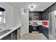 Modern kitchen featuring stainless steel appliances and sleek black cabinetry at 117 Langhorne Dr, Mount Holly, NC 28120