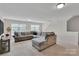Spacious living room features carpet, neutral walls and a large sectional sofa at 117 Langhorne Dr, Mount Holly, NC 28120